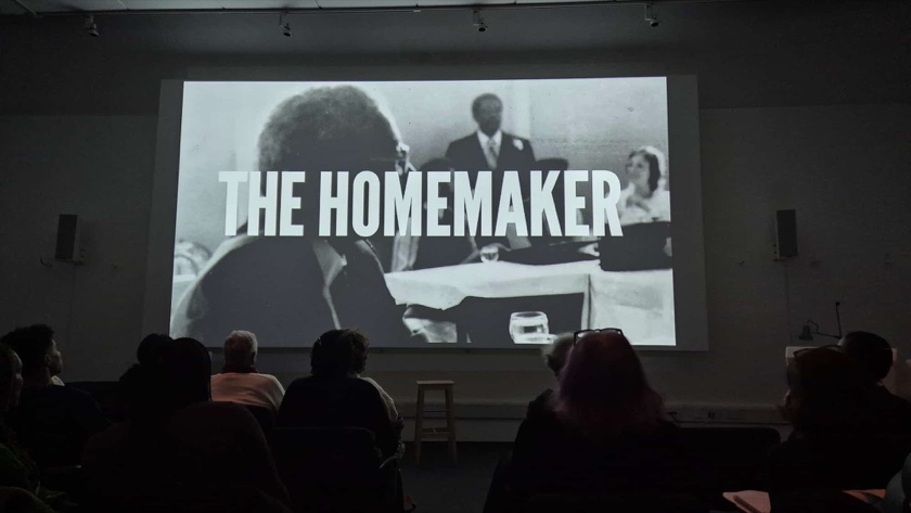 A live audience watching The Homemaker projected on a screening-room screen